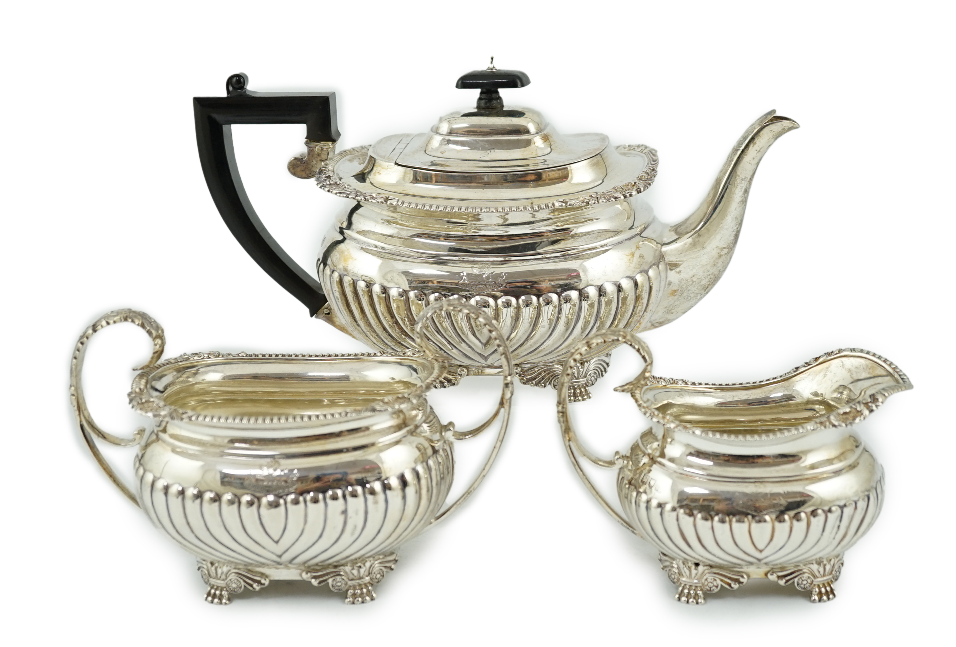 A late Victorian demi fluted silver three piece tea set, by The Barnards